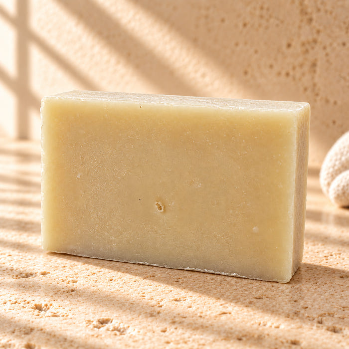 The Gentleman soap — AI-styled limestone setting using the product photograph.